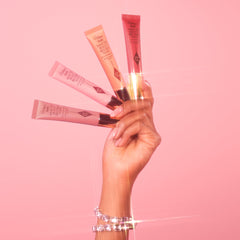 Charlotte Tilbury in a beauty bag lifestyle shot illustrating on-the-go touch-ups