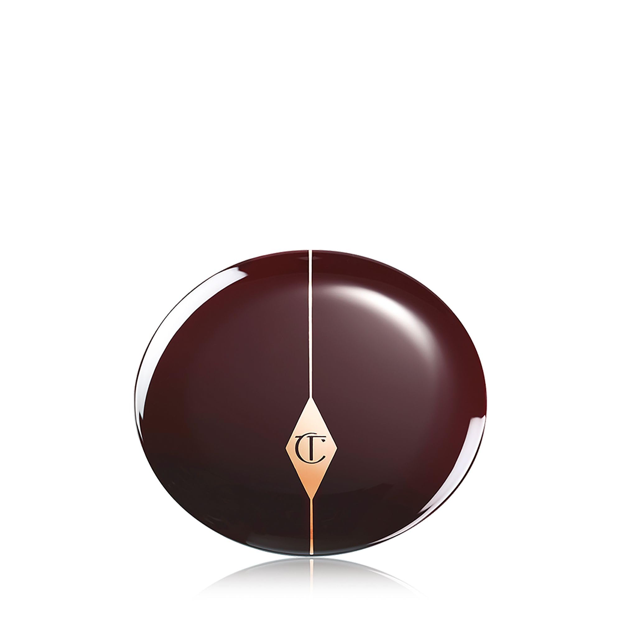 Charlotte Tilbury open pan next to brush showing product size and how much to pick up