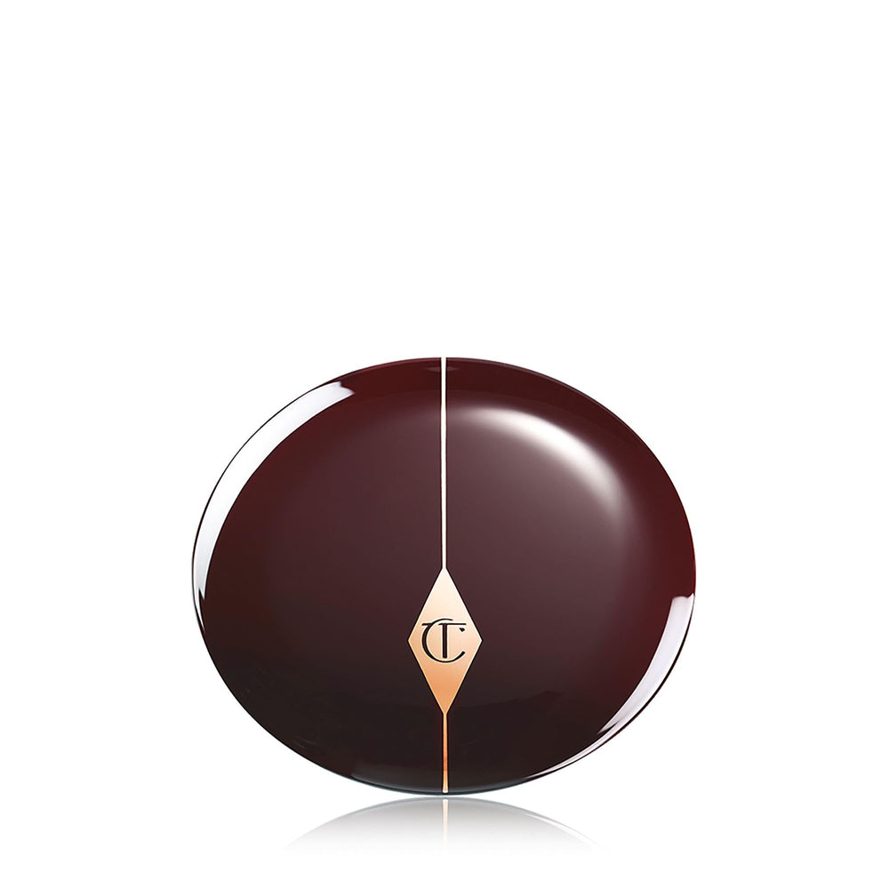 Charlotte Tilbury open pan next to brush showing product size and how much to pick up