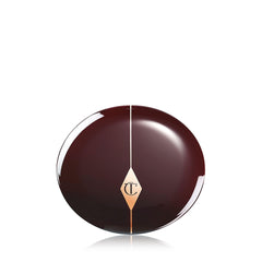 Charlotte Tilbury open pan next to brush showing product size and how much to pick up