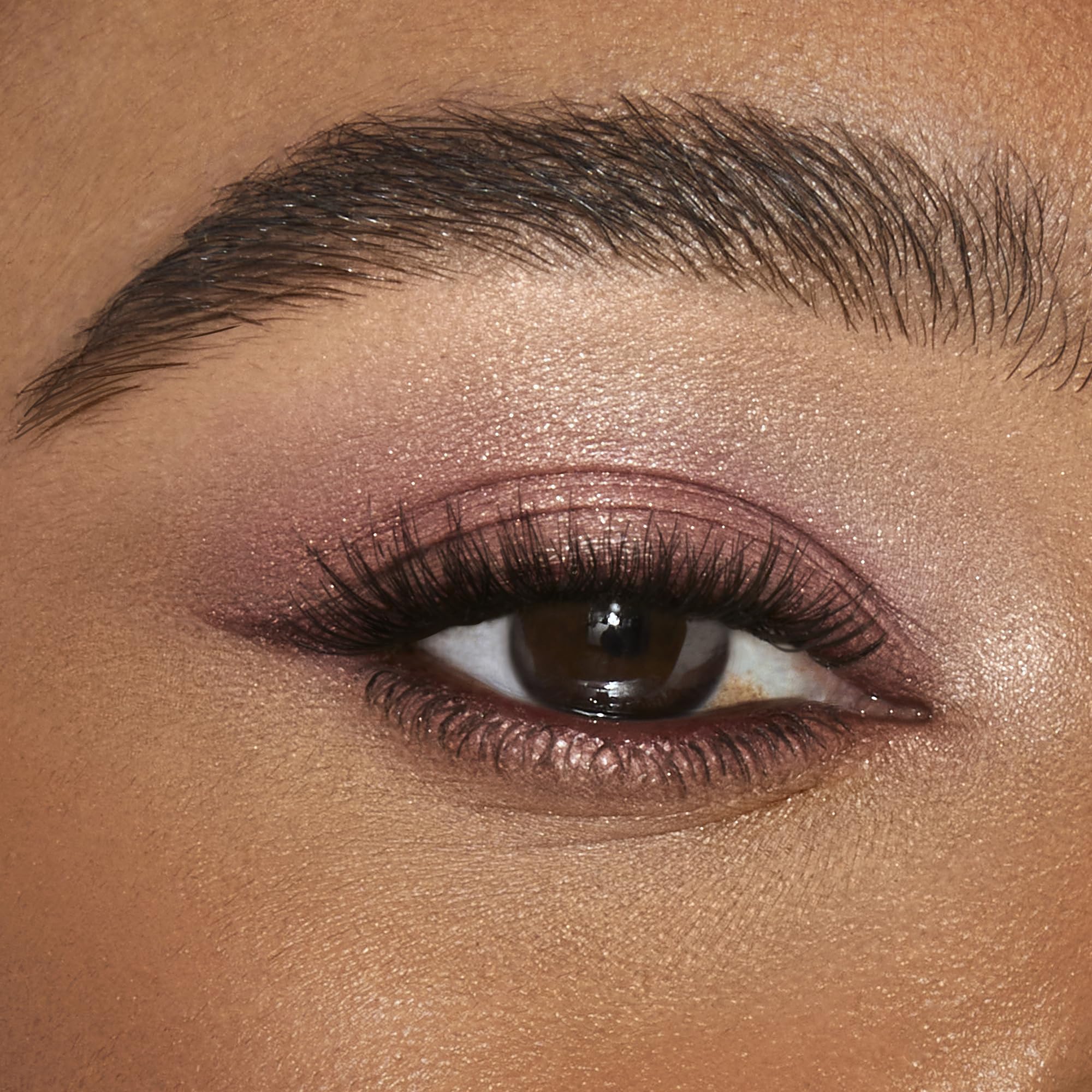 Charlotte Tilbury swatch on skin demonstrating Pillow Talk glow and buildable coverage