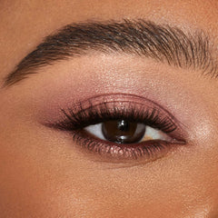 Charlotte Tilbury swatch on skin demonstrating Pillow Talk glow and buildable coverage