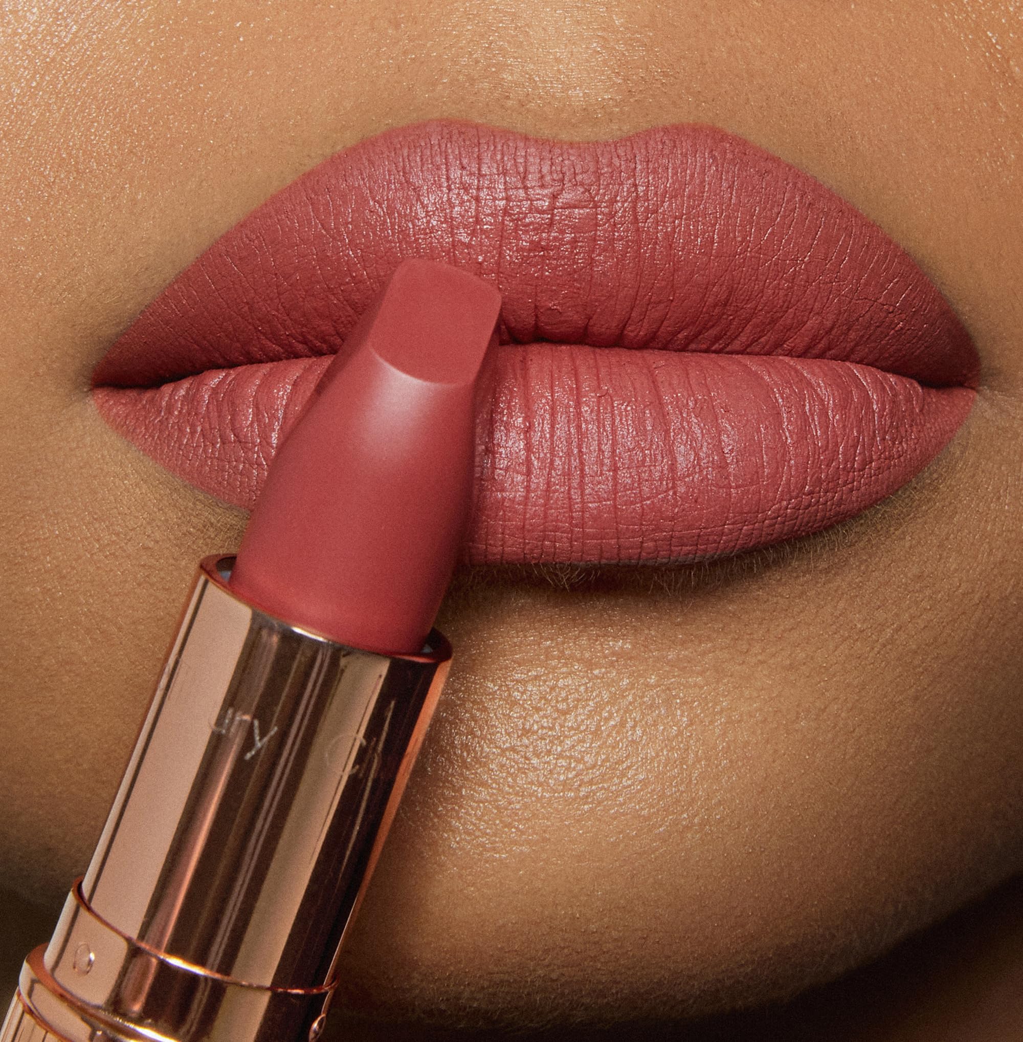 Charlotte Tilbury Sexy Sienna worn on lips in studio, enhancing natural fullness benefit