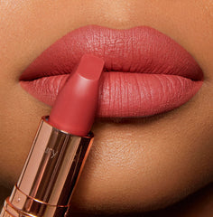 Charlotte Tilbury Sexy Sienna worn on lips in studio, enhancing natural fullness benefit