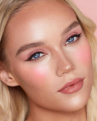 Charlotte Tilbury travel-ready wand tucked into a small pouch highlighting TSA-friendly portability