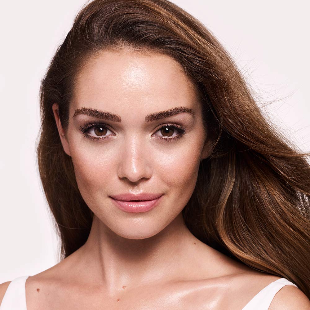 Charlotte Tilbury primer in bathroom routine setting showing quick daily glow benefit