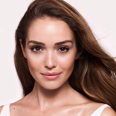 Charlotte Tilbury primer in bathroom routine setting showing quick daily glow benefit