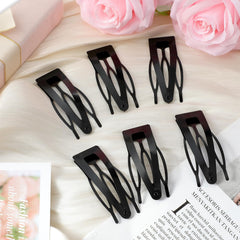 Chinco clip used to pin back bangs demonstrating tidy styling benefit