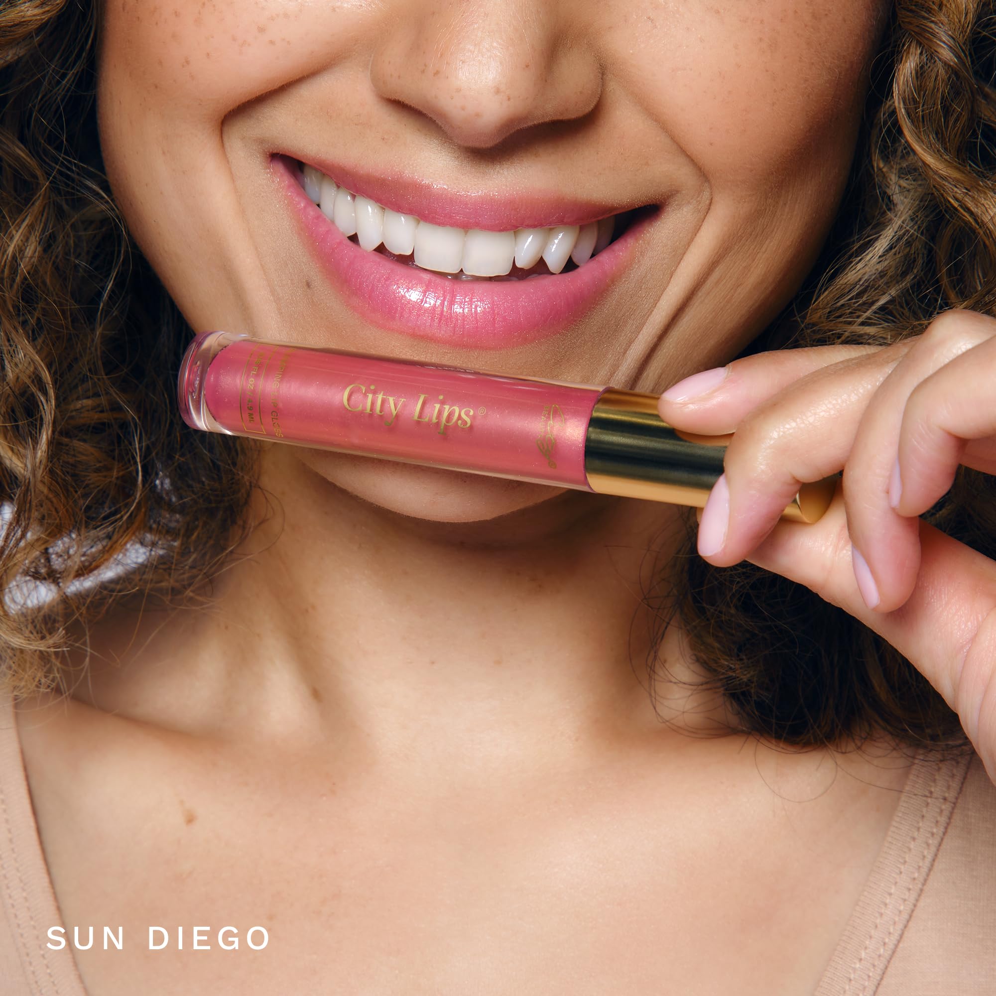 City Beauty City Lips applied on lips in-hand showing fuller look and comfortable wear