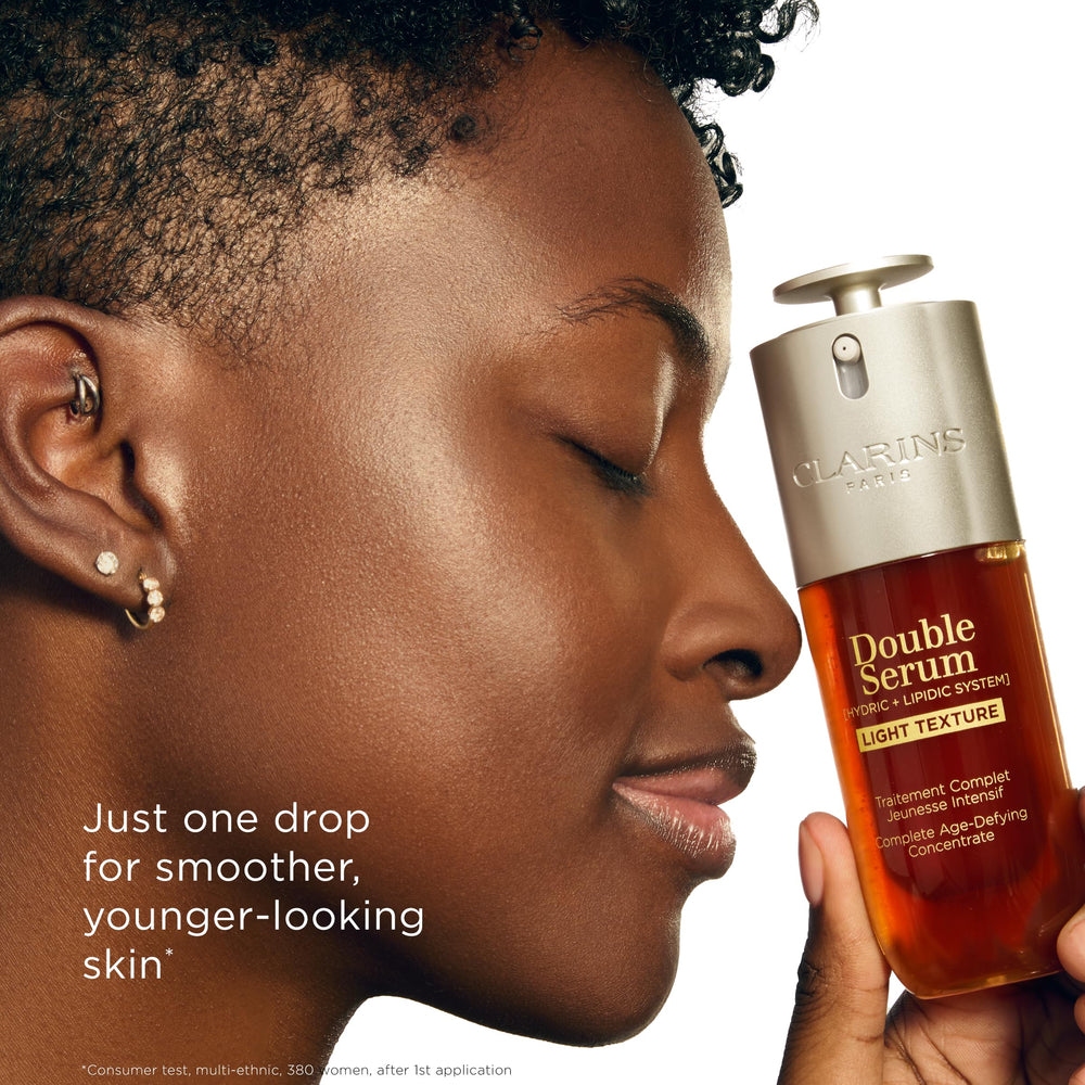 Clarins bottle in bathroom lifestyle setting suggesting daily routine compatibility