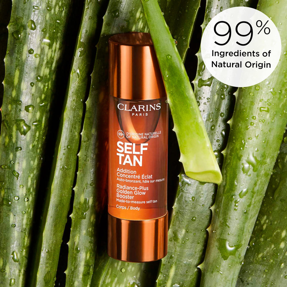 CLARINS 1 oz bottle next to a coin for size and travel-friendly benefit