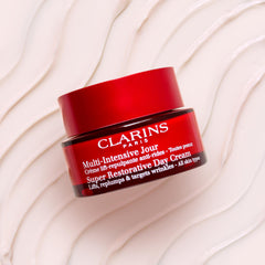 Clarins cream being scooped with fingers for easy application benefit