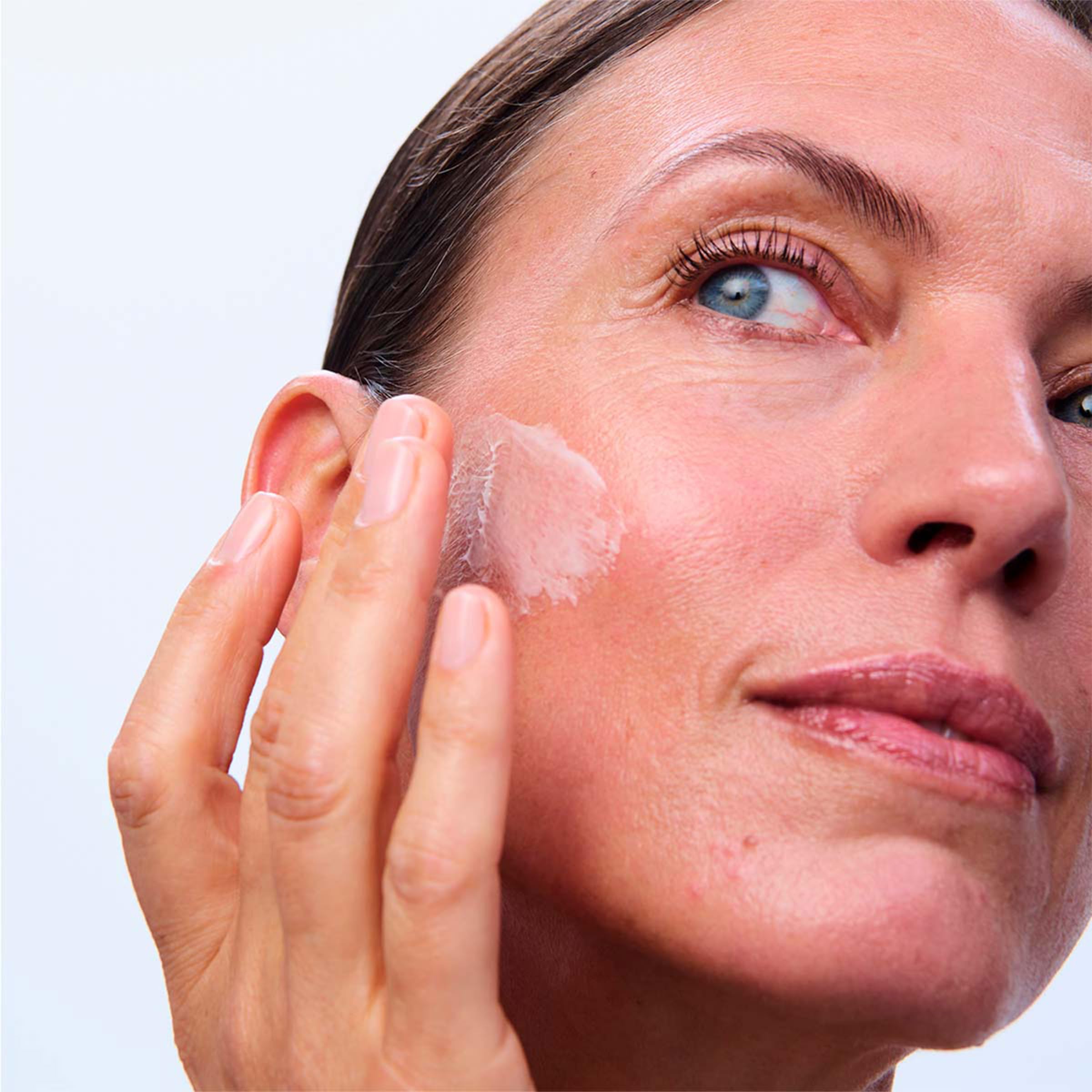 Clarins applied on woman's face during morning routine for lifted appearance