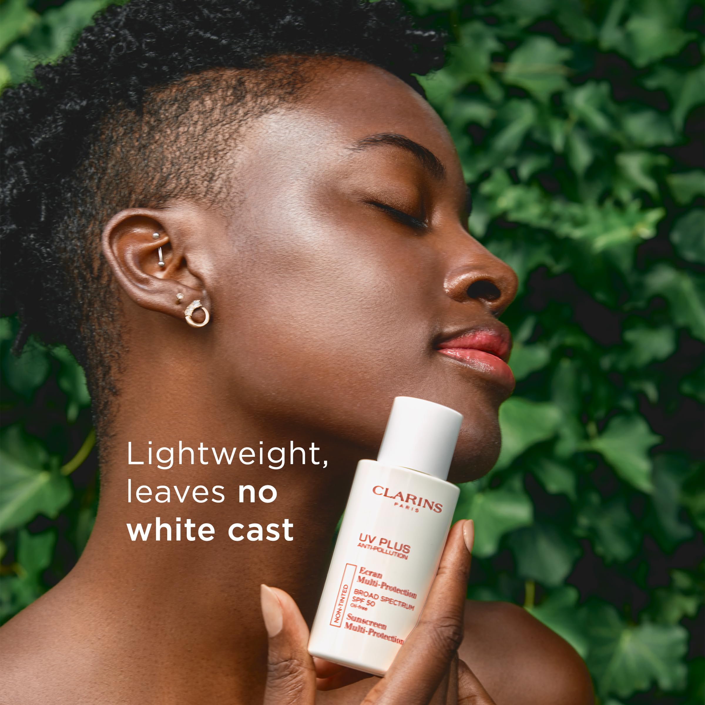 Clarins UV Plus applied to cheek showing invisible finish and makeup compatibility