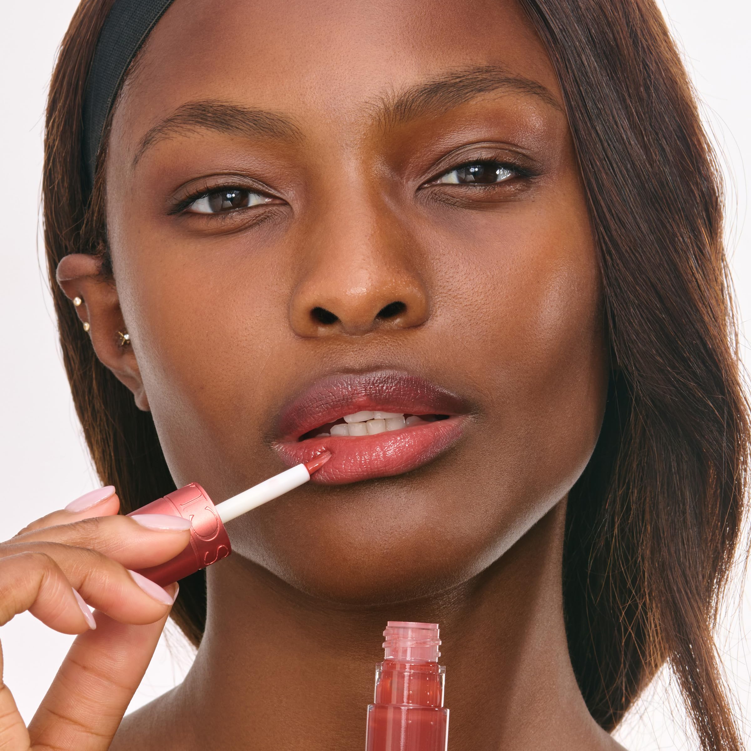 clarins Water Lip Stain size scale next to fingers shows portable 0.2 fl oz convenience