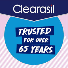 Clearasil patch beside fingers for scale, shows small size and targeted use