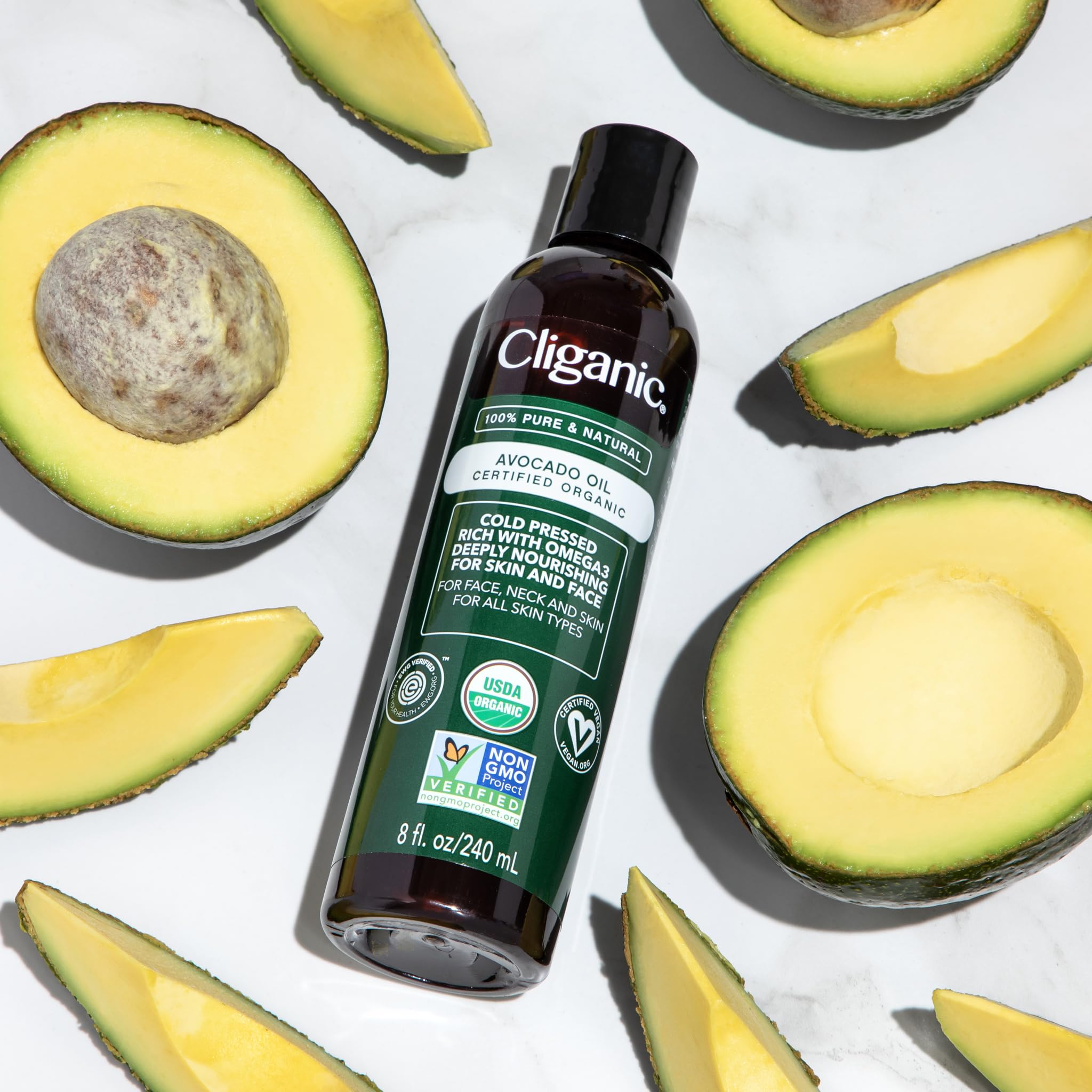 Cliganic pouring cold-pressed avocado oil to show clarity and purity