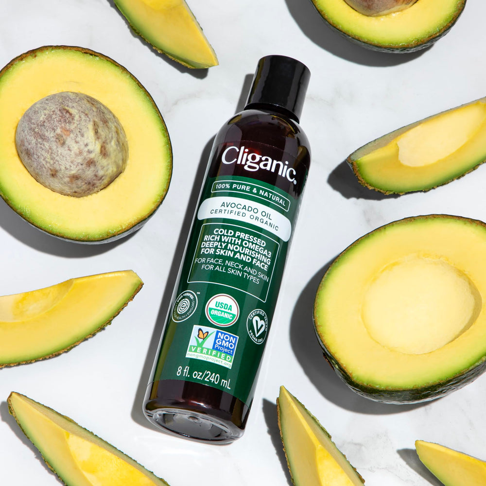 Cliganic pouring cold-pressed avocado oil to show clarity and purity