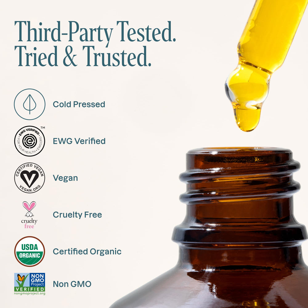 Person applying Cliganic rosehip oil to hair ends for frizz control and shine