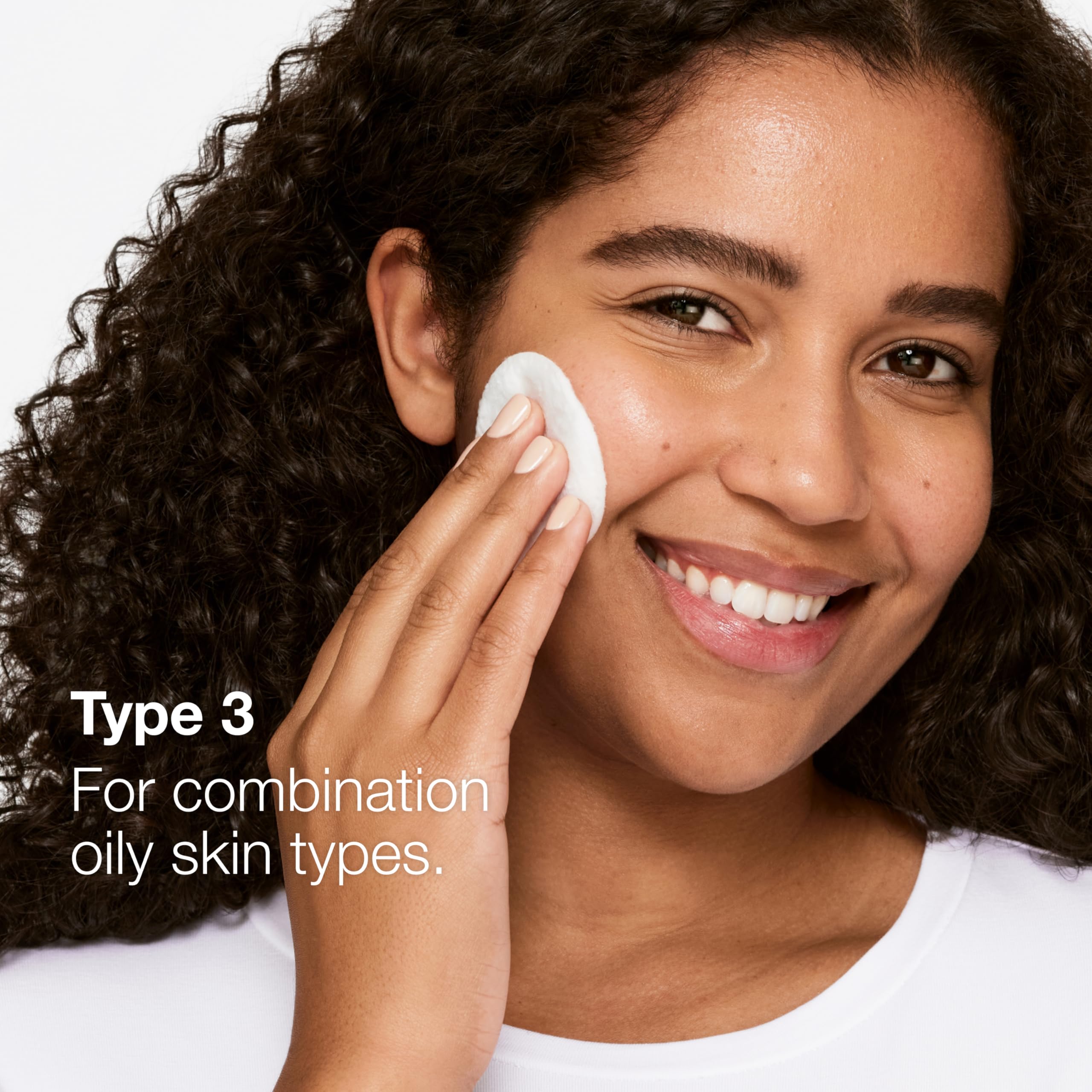 Hand applying Clinique Clarifying Lotion 3 to show easy, controlled use
