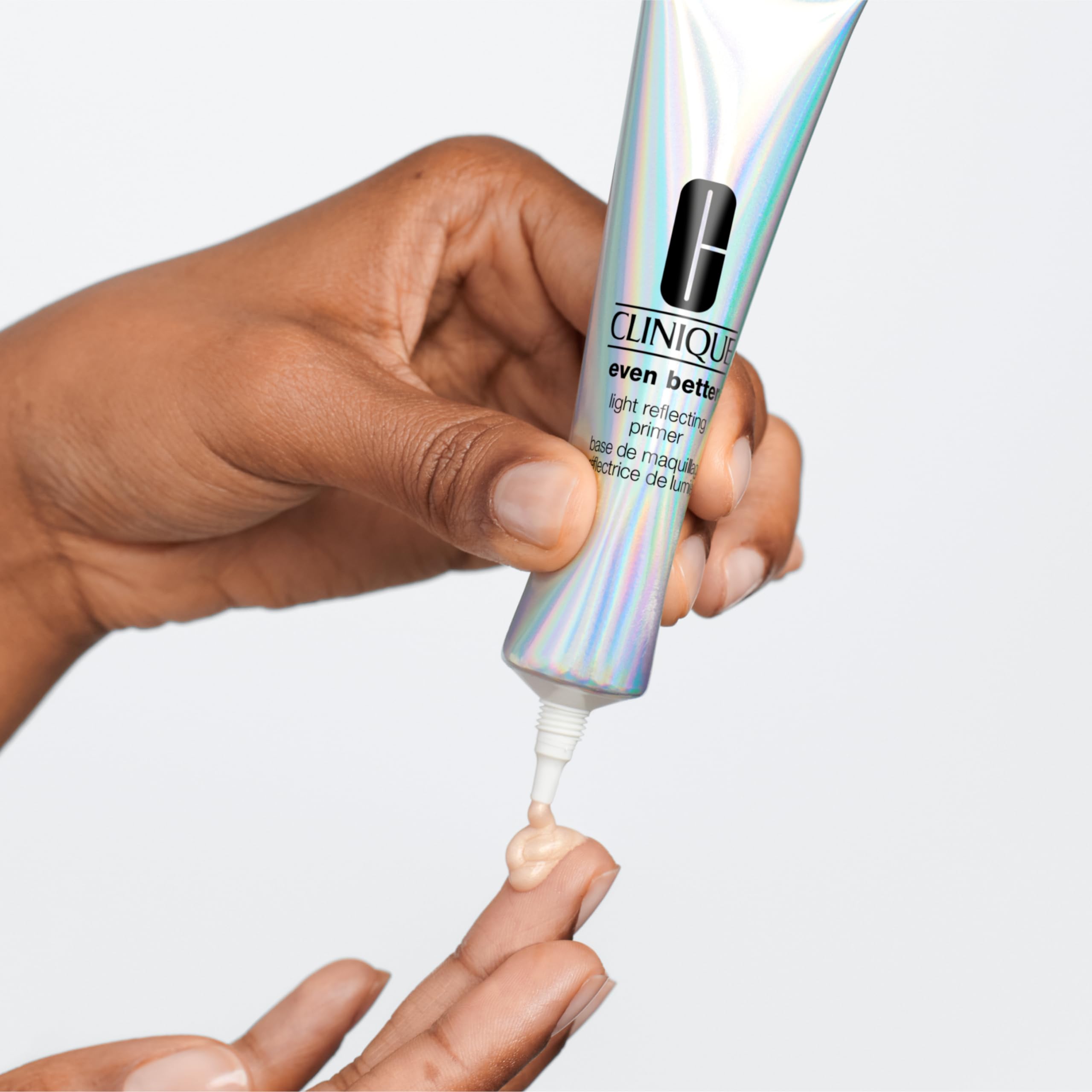 Clinique primer beside a hand for scale showing travel-ready one ounce convenience benefit