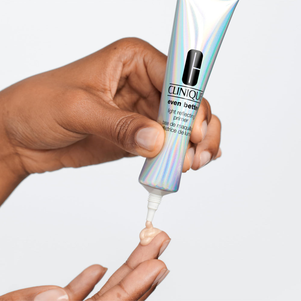 Clinique primer beside a hand for scale showing travel-ready one ounce convenience benefit