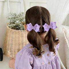 CN hair bow clipped in child's hair demonstrating cute festive look