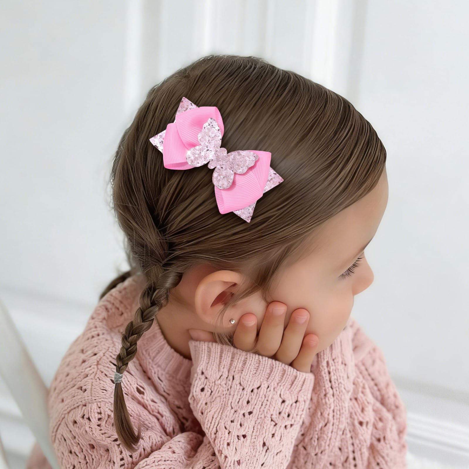 CN child wearing bows outdoors highlighting sparkle in sunlight and charm