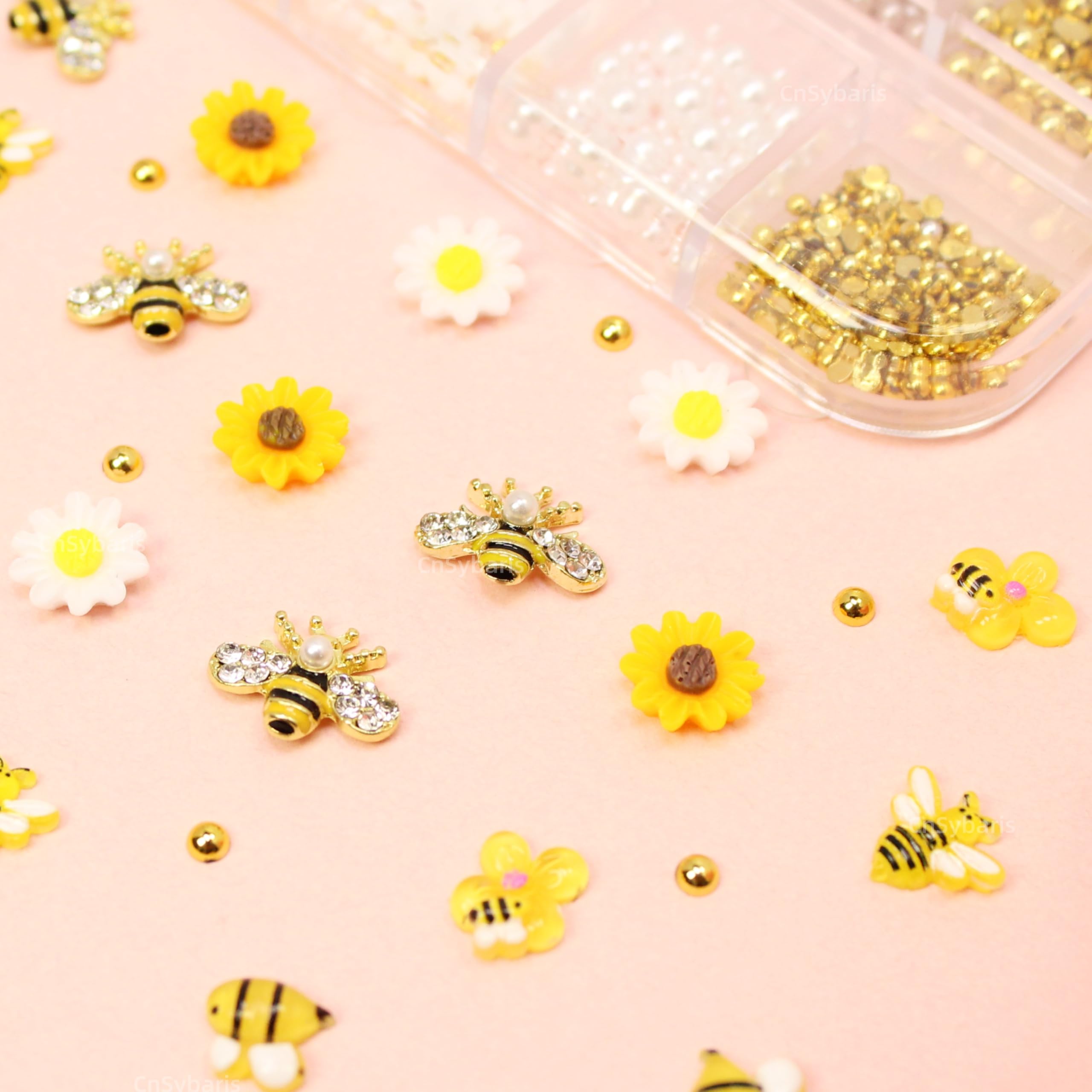 CnSybaris lifestyle image of spring manicure featuring bee and daisy charms for seasonal style