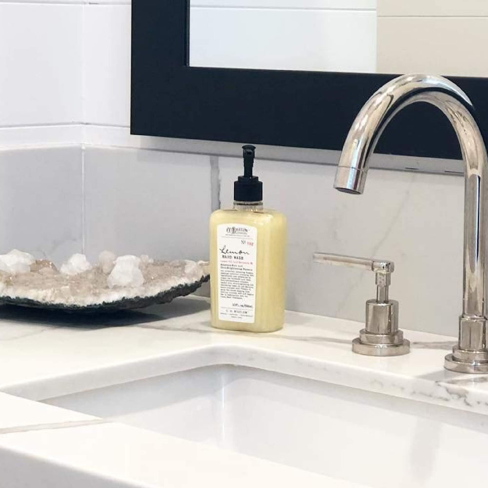 C. O. Bigelow bottle beside fresh lemons emphasizing natural lemon fragrance