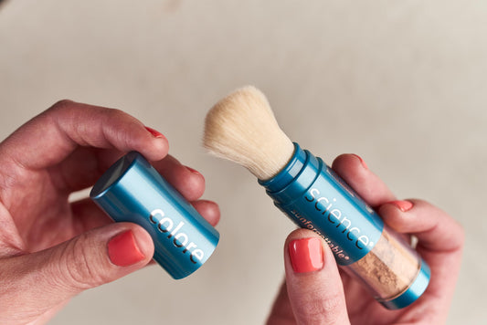 Colorescience Bronze brush in use applying powder for seamless reapplication