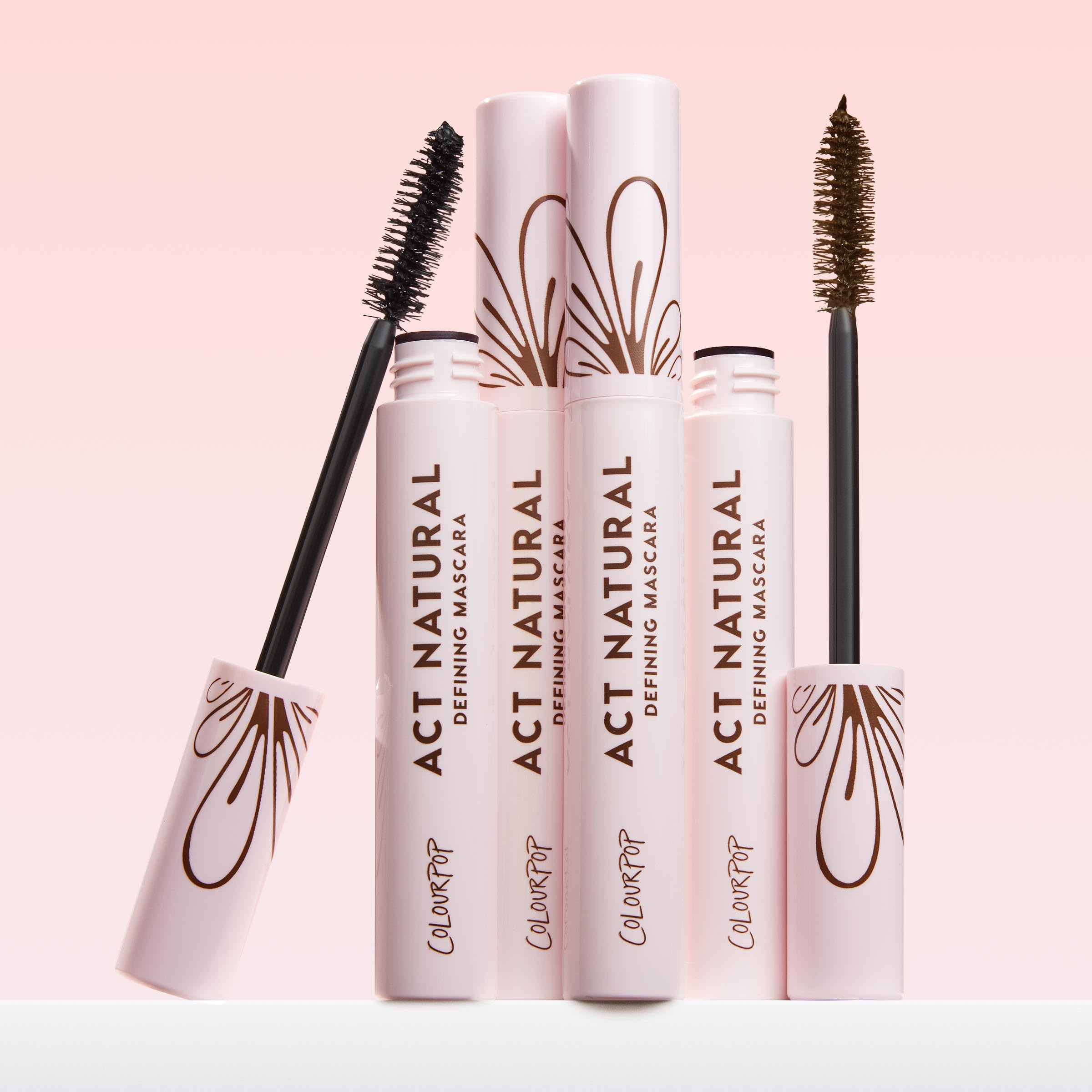 ColourPop Act Natural next to eyeshadow and brushes in a vanity setting, completes eye looks