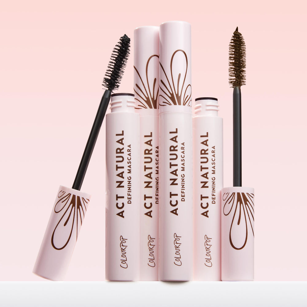 ColourPop Act Natural next to eyeshadow and brushes in a vanity setting, completes eye looks