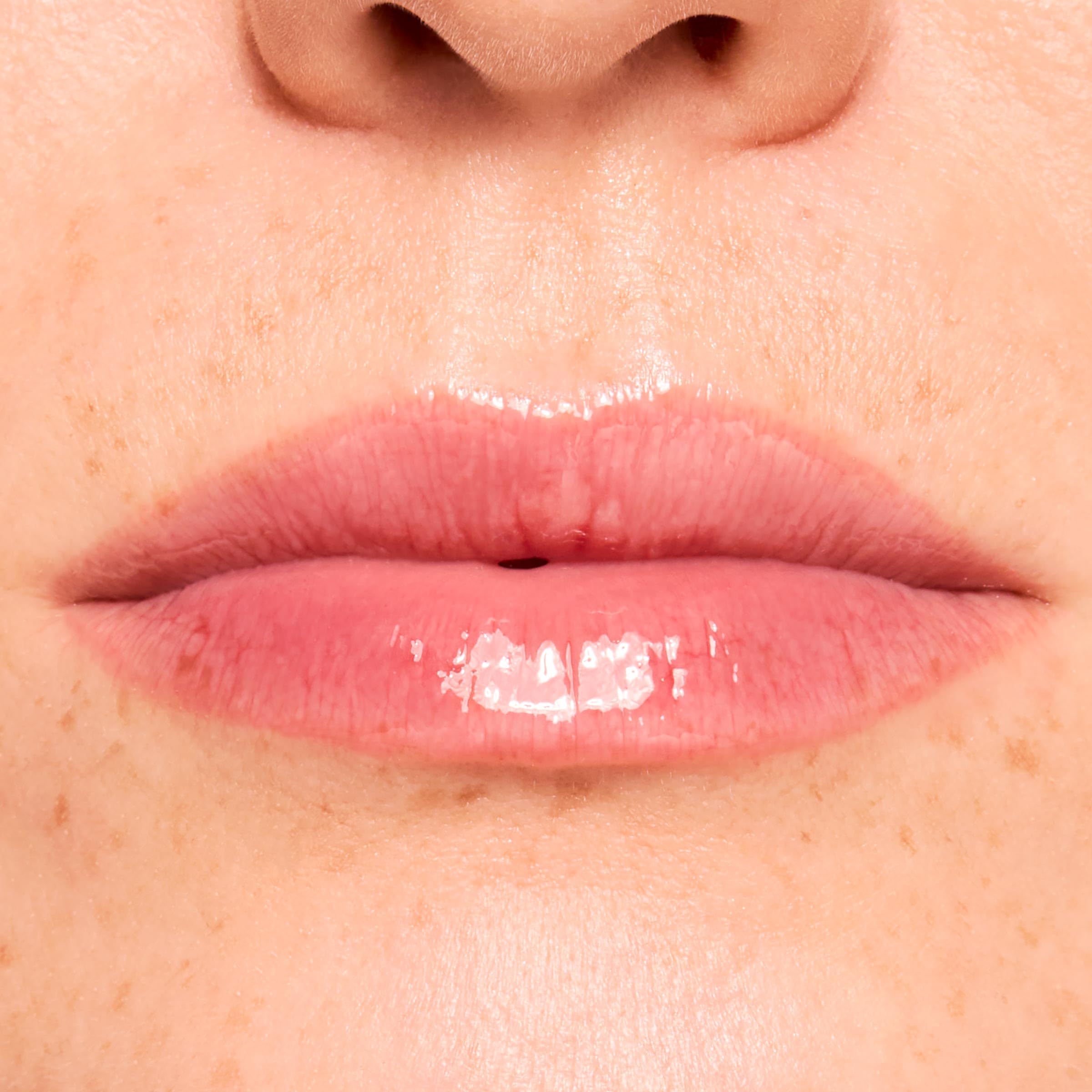 ColourPop Fresh Kiss Wild Berry layered over lipstick adding shine benefit