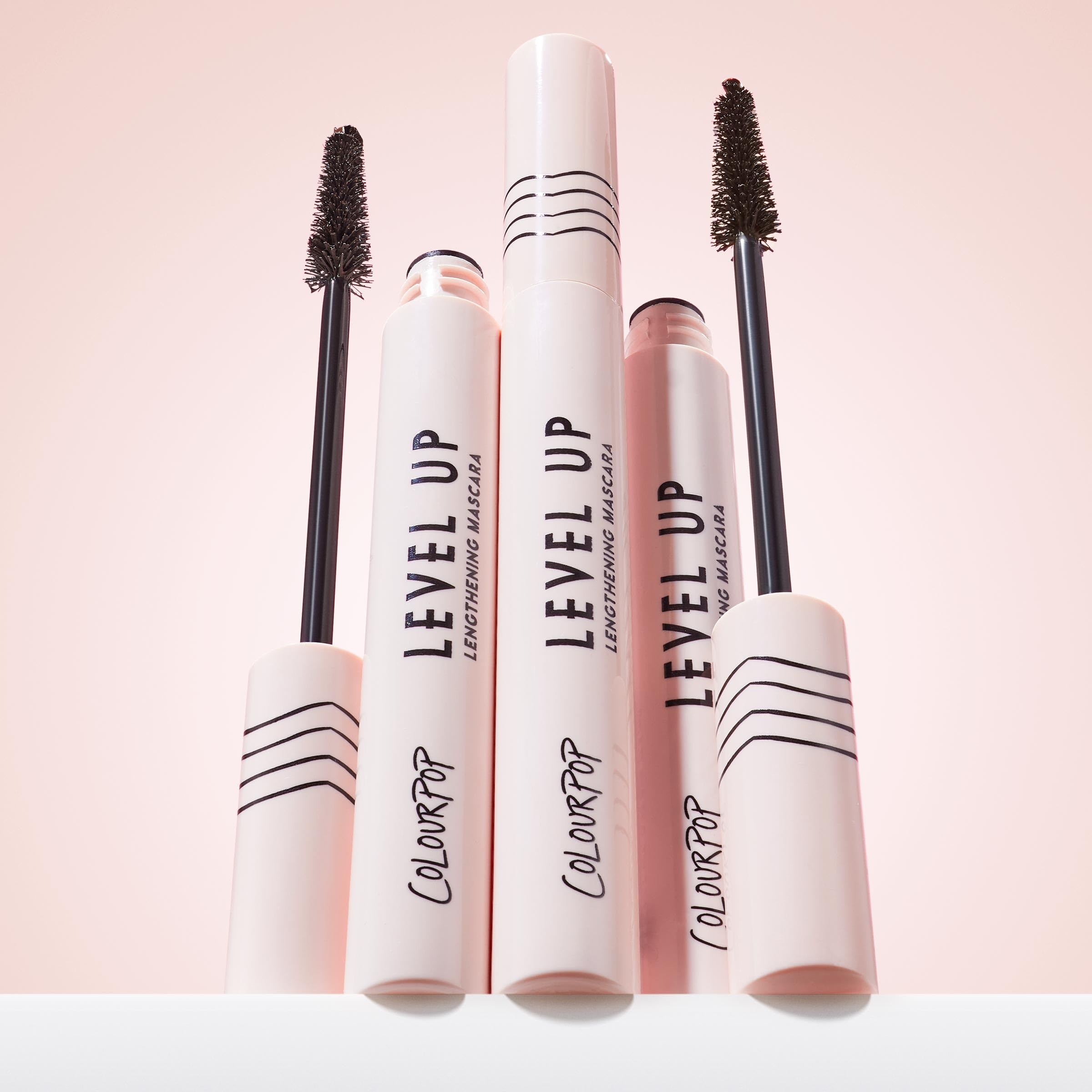 ColourPop mascara tube next to coin illustrating compact size for travel convenience