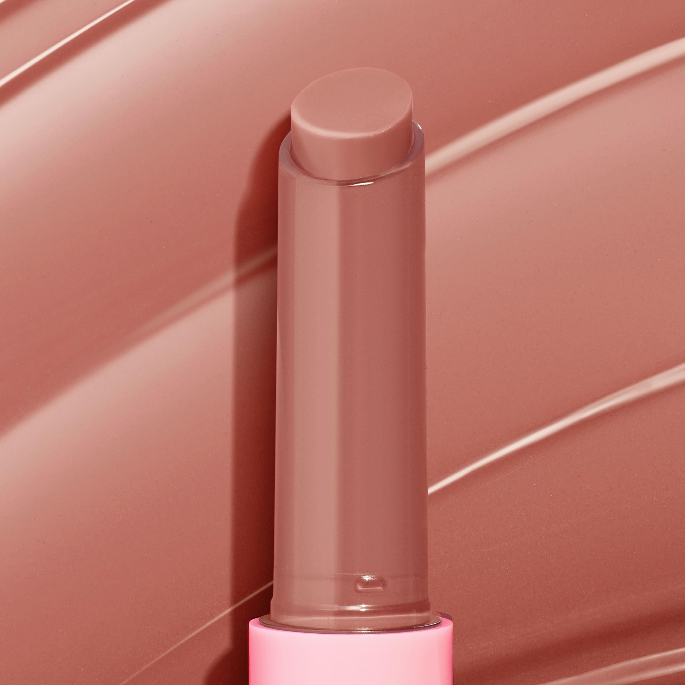 ColourPop tube beside hand for scale showing travel-friendly compact size benefit