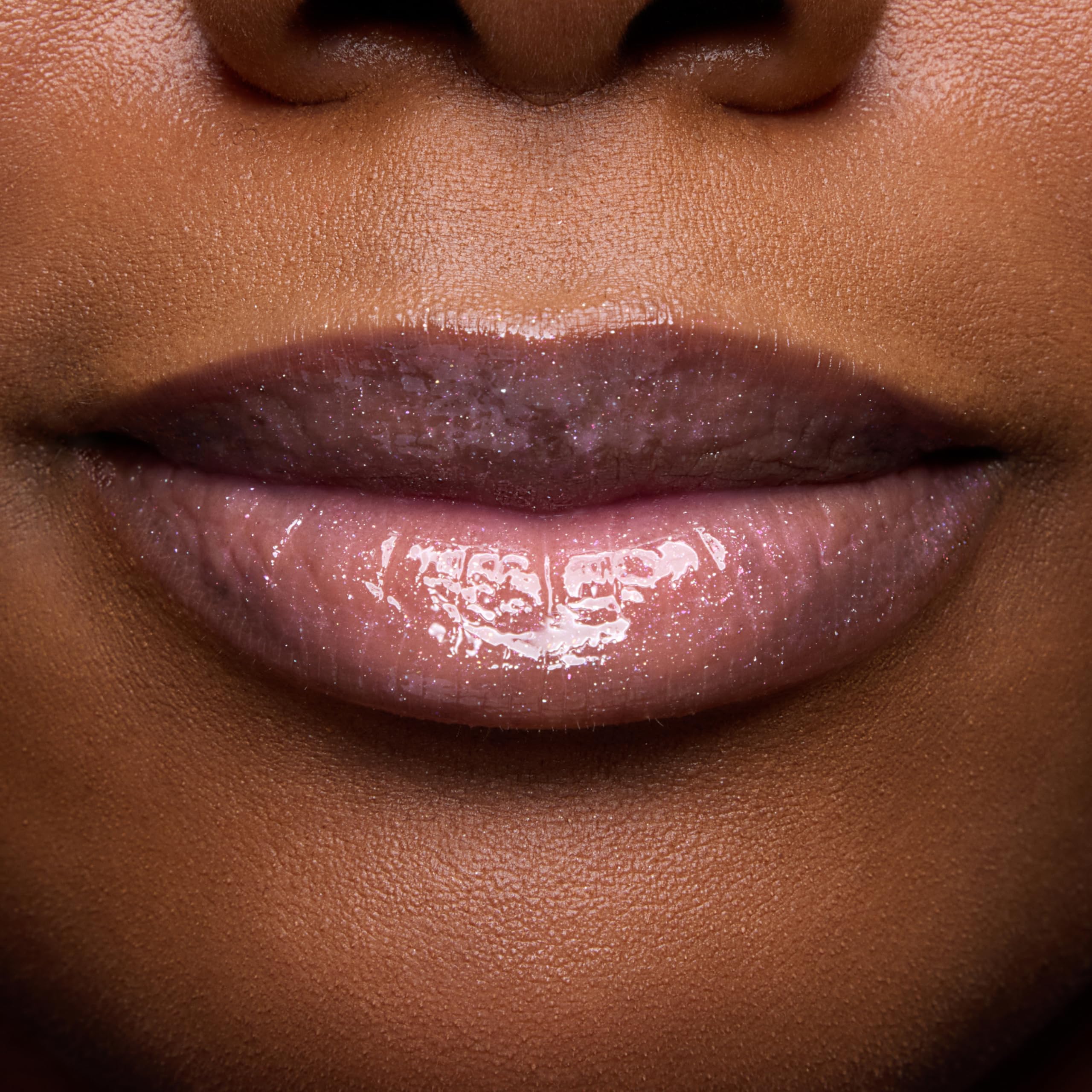 ColourPop swatch on arm showing sheer rosy tint and luminous shine benefit