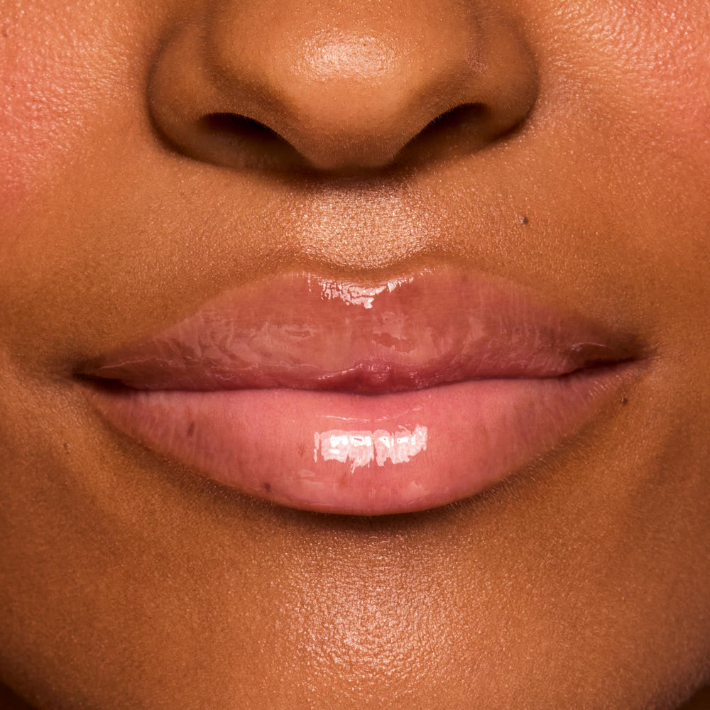 ColourPop swatch on hand showing sheer vanilla tint and glossy reflect for true-to-life color