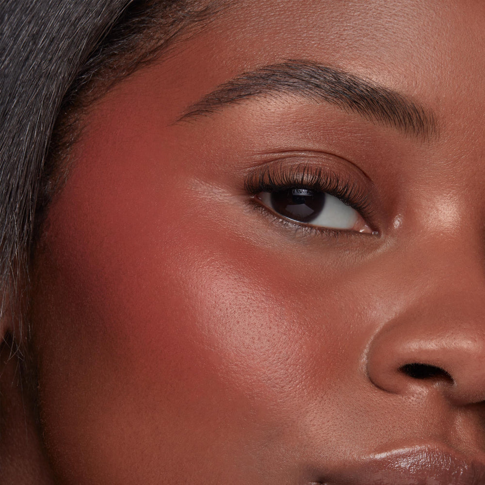 ColourPop swatch on arm showing buildable rosy-pink pigment