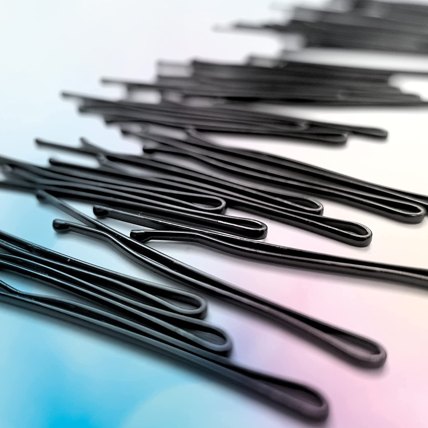 Conair pins beside ruler showing 2 inch length, clear size reference
