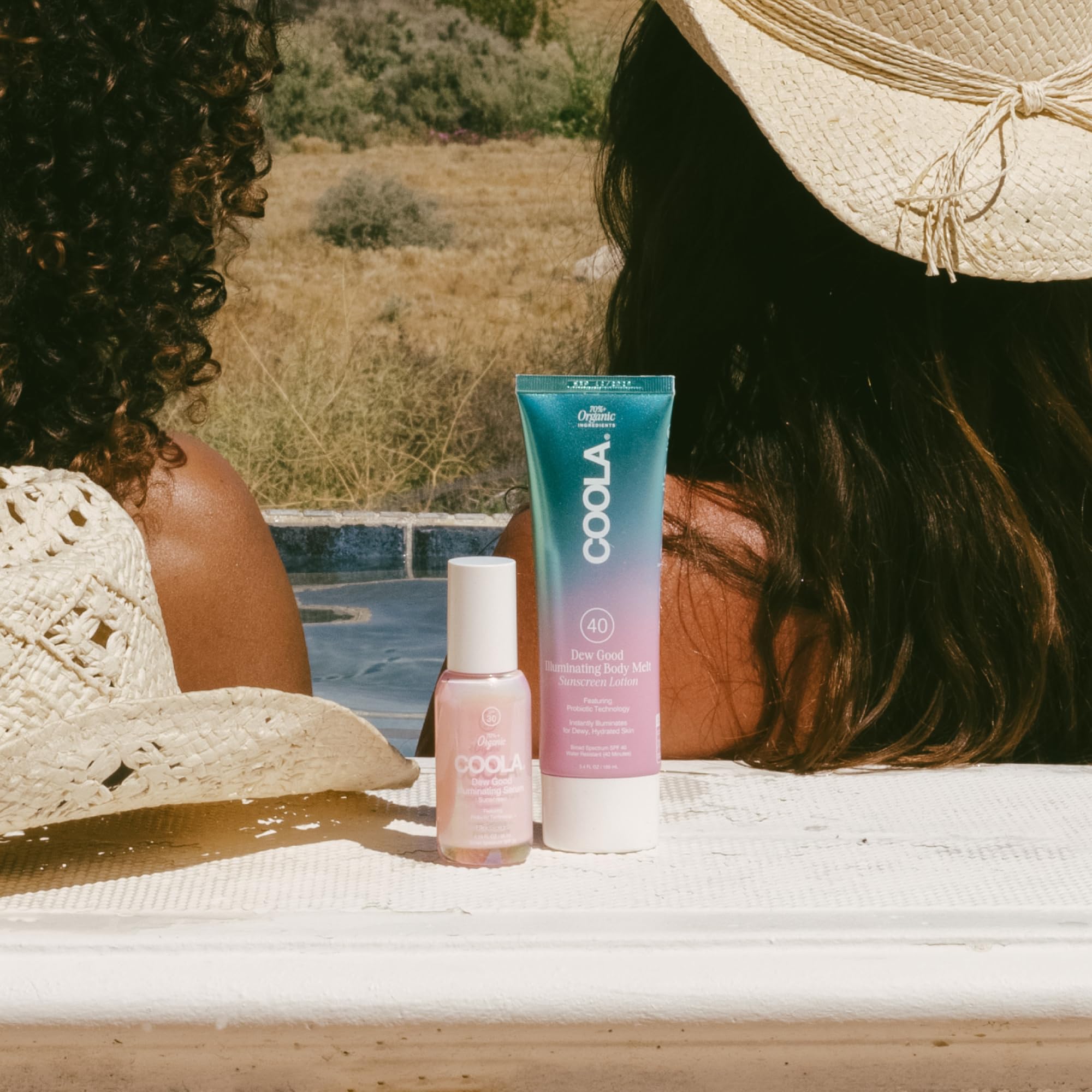 COOLA body melt on skin showing dewy illuminated finish and soft hydration