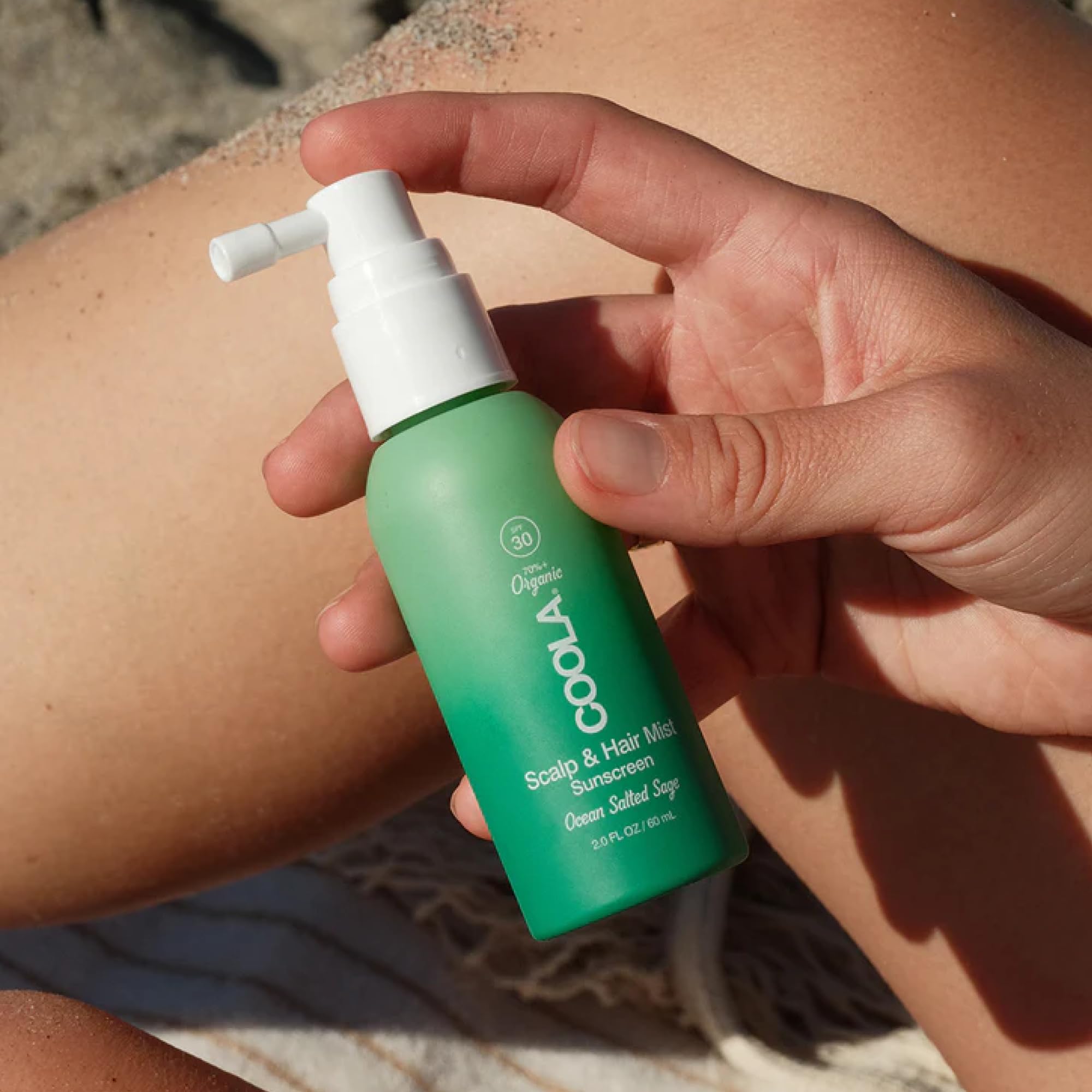 COOLA spraying roots and scalp for targeted sun protection benefit