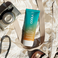COOLA tube on sandy beach conveying outdoor protection and lifestyle use