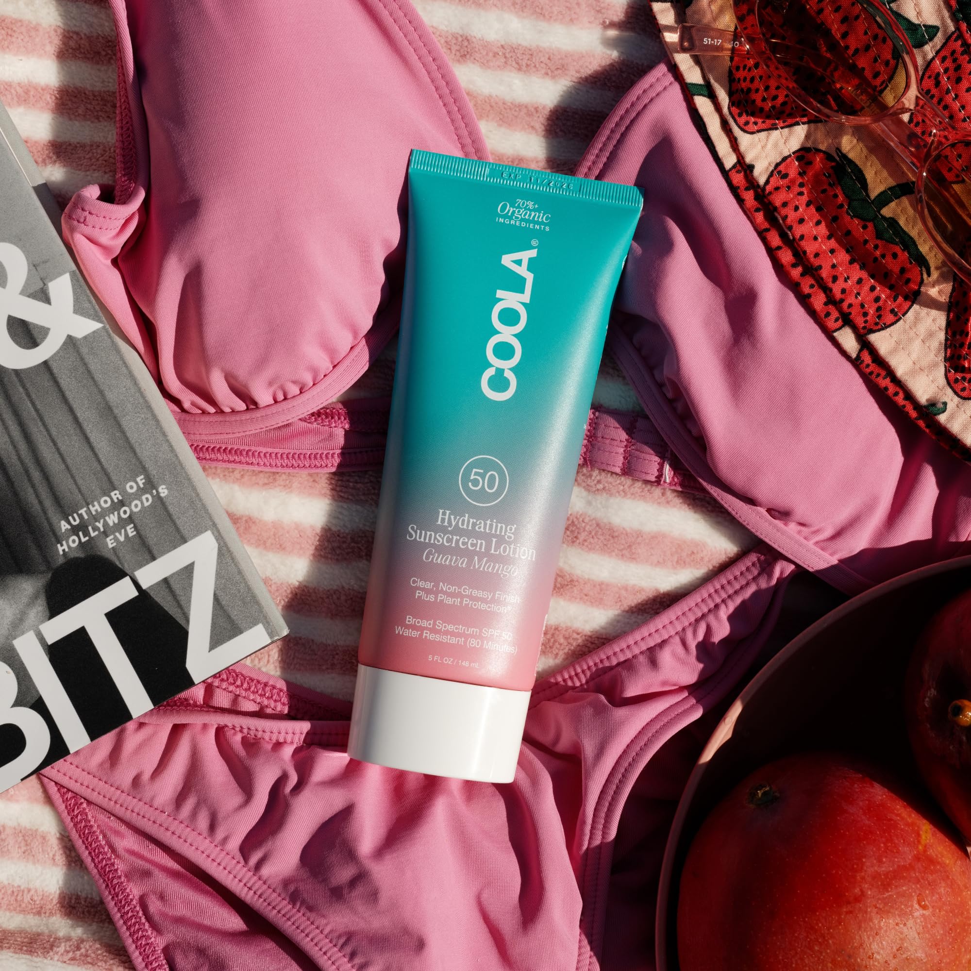COOLA tube in beach lifestyle scene conveying outdoor-ready protection benefit