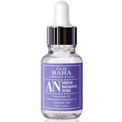 Cos De BAHA bottle beside natural botanical extracts showing gentle formulation