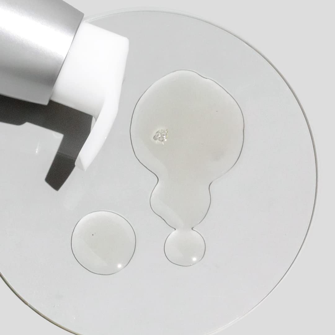 COSMEDIX bottle next to hand to show 100 ml size and travel-friendly benefit