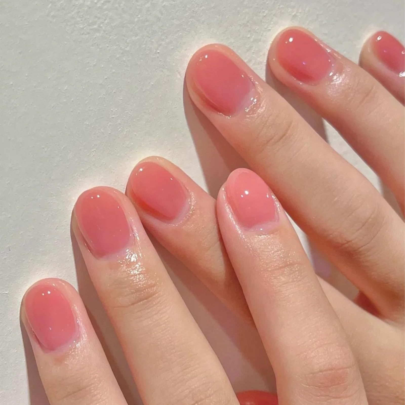 COSMOO applied on fingernails showcasing sheer peach look and shine