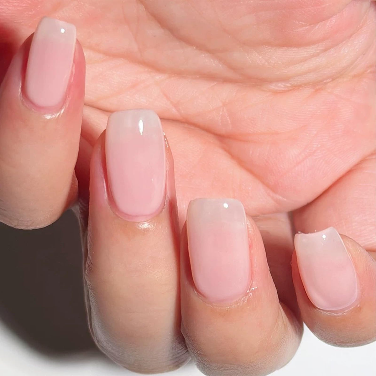 COSMOO bottle front view showing pale pink shade and benefits