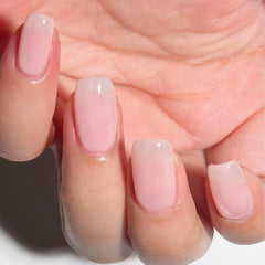 COSMOO bottle front view showing pale pink shade and benefits