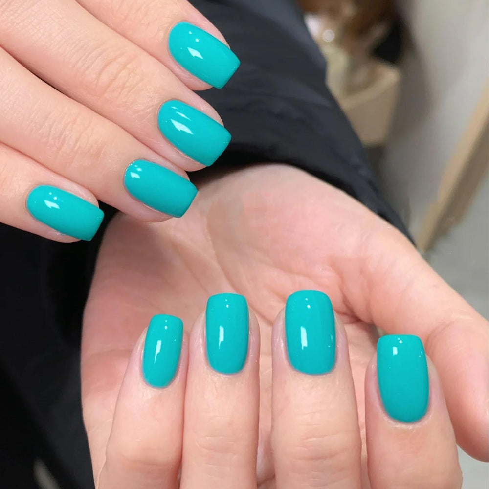 COSMOO polish on nail closeup displaying glossy red finish and chip resistance